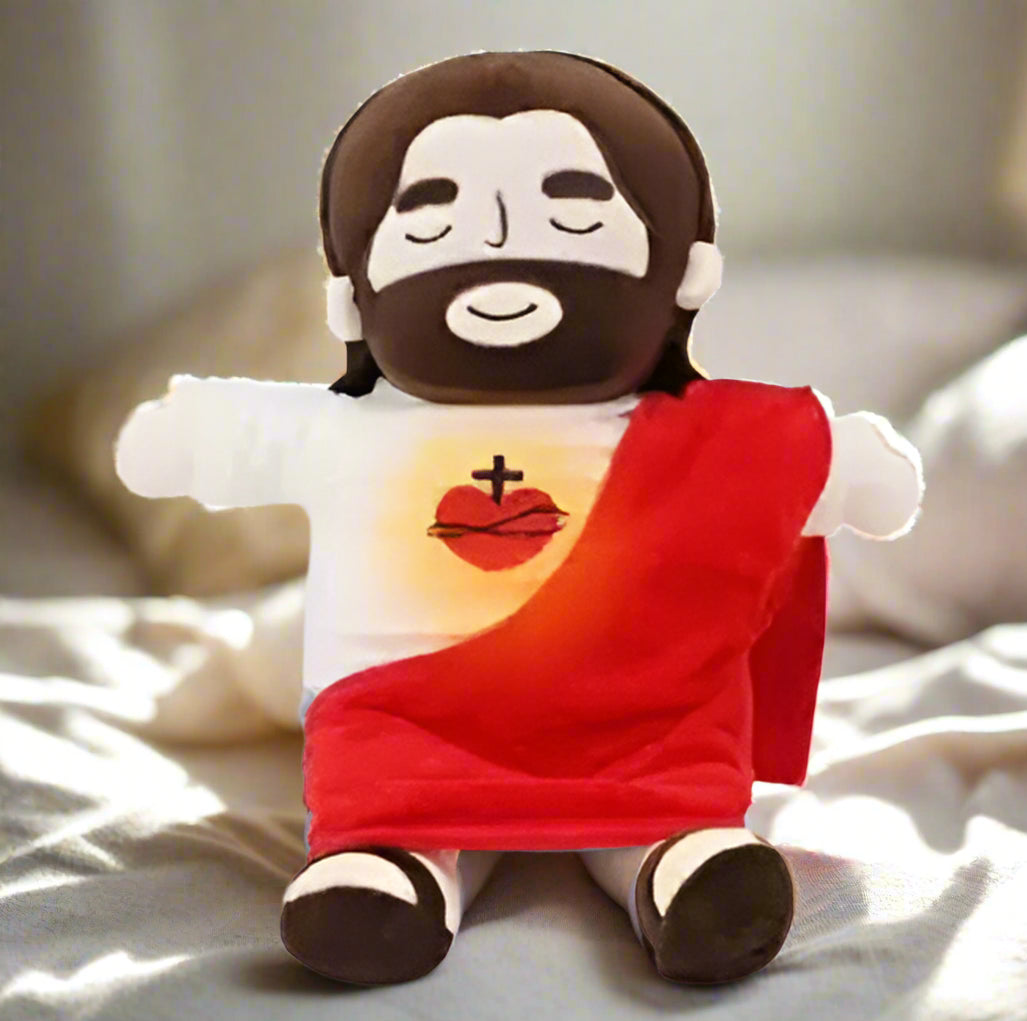 Plush toy resembling a religious figure with a red robe and white face on a white background